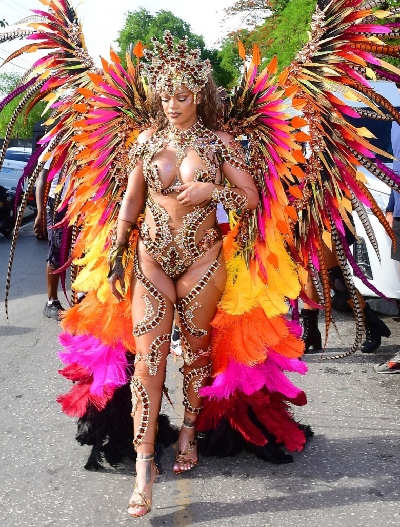 *EXCLUSIVE* Singer Rihanna Stuns at Carnival Festival In Barbados showcasing her 2024 outfit in a bejeweled bikini as she poses with police and fans