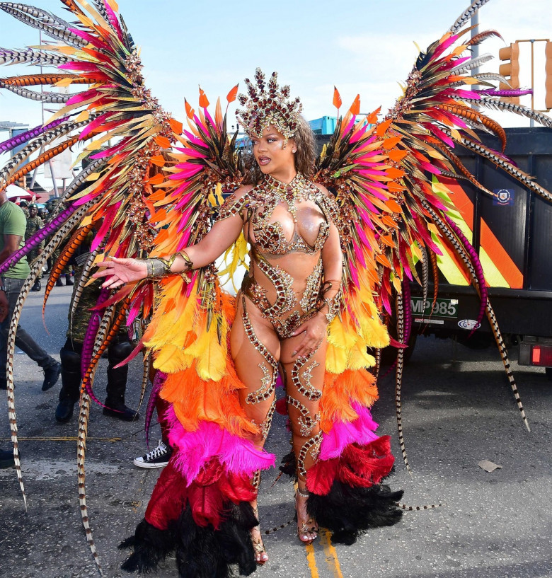 *EXCLUSIVE* Singer Rihanna Stuns at Carnival Festival In Barbados showcasing her 2024 outfit in a bejeweled bikini as she poses with police and fans