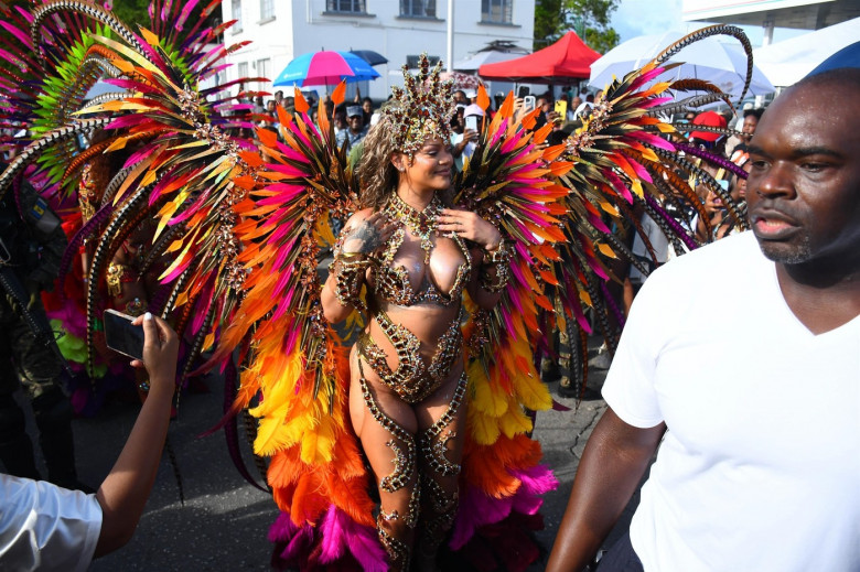 *EXCLUSIVE* Singer Rihanna Stuns at Carnival Festival In Barbados showcasing her 2024 outfit in a bejeweled bikini as she poses with police and fans