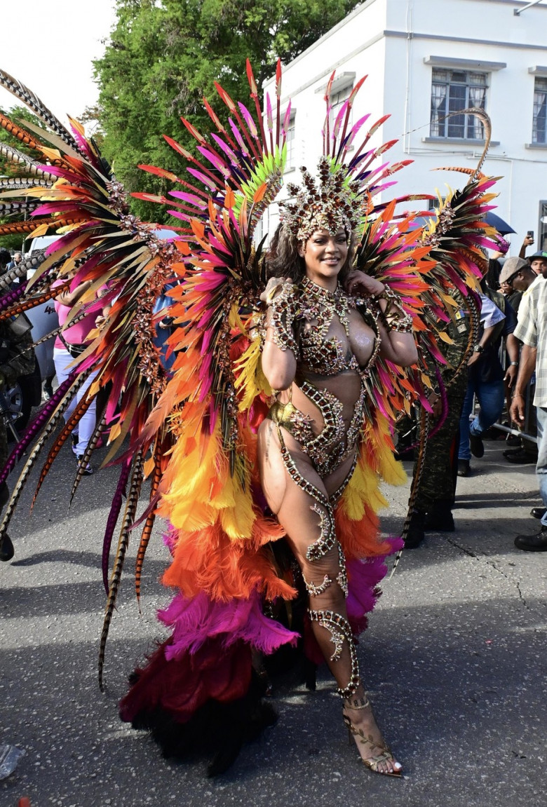 *EXCLUSIVE* Singer Rihanna Stuns at Carnival Festival In Barbados showcasing her 2024 outfit in a bejeweled bikini as she poses with police and fans