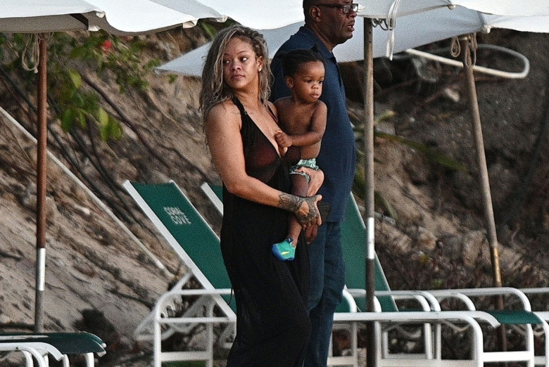 *PREMIUM-EXCLUSIVE* *MUST CALL FOR PRICING* The Grammy-Winning Superstar Rihanna wears her sultry black maxi beach dress watching the sun go down and taking a dip in the sea with her beau Asap Rocky during their family holiday in Barbados.**PICTURES TAKE