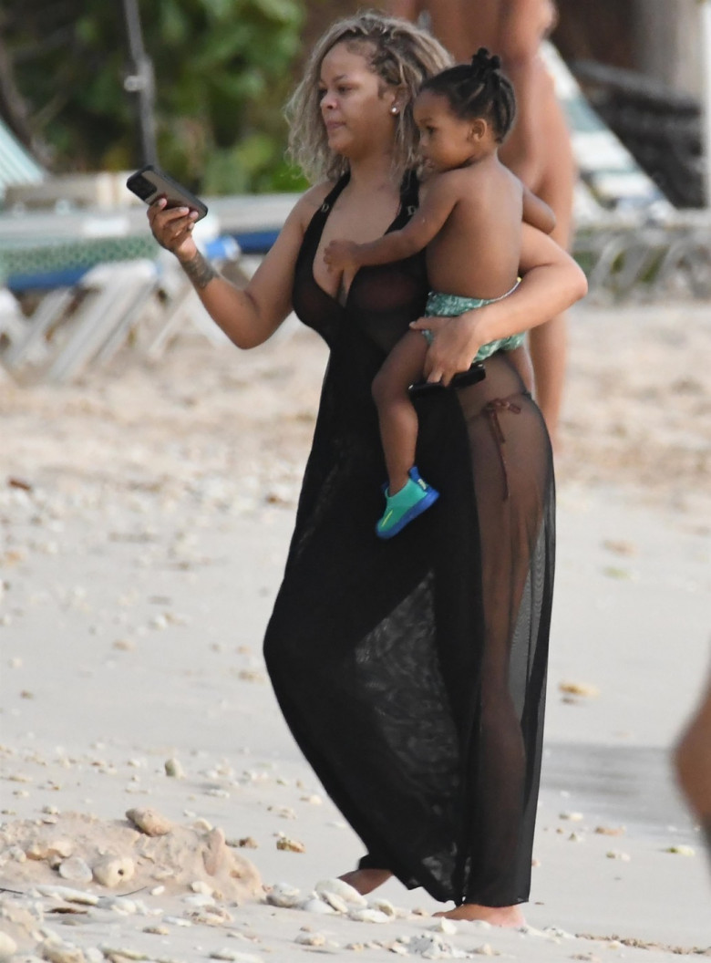 *PREMIUM-EXCLUSIVE* *MUST CALL FOR PRICING* The Grammy-Winning Superstar Rihanna wears her sultry black maxi beach dress watching the sun go down and taking a dip in the sea with her beau Asap Rocky during their family holiday in Barbados.**PICTURES TAKE