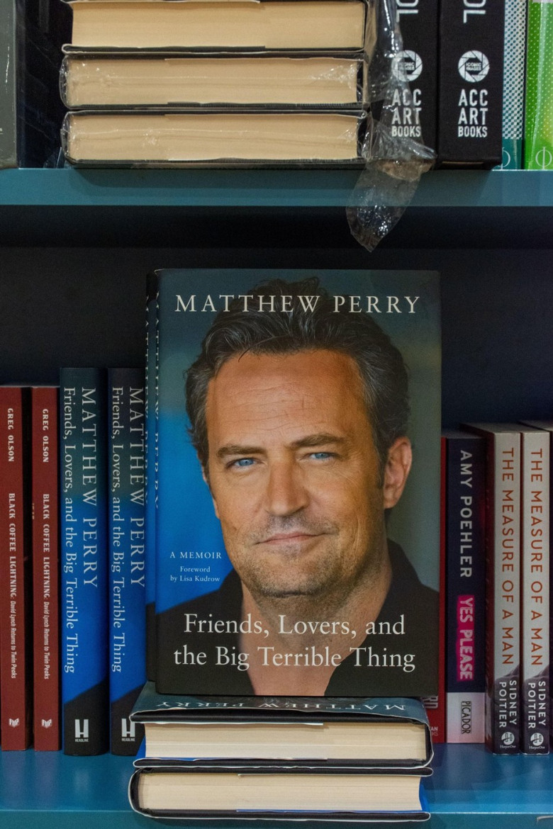 Close-up Matthew Perry's Friends, Lovers, and the Big Terrible Thing book on a bookshelf in the bookstore.