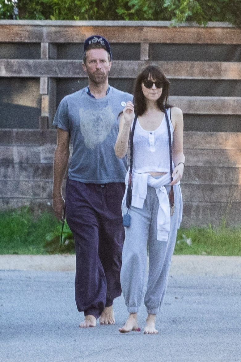 *EXCLUSIVE* Dakota Johnson takes a break from filming to be by Chris Martin's side as he recovers from lung infection that forced cancellation of some Coldplay shows! - ** WEB MUST CALL FOR PRICING **