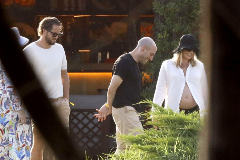 *PREMIUM-EXCLUSIVE* MUST CALL FOR PRICING BEFORE USAGE  - Heavily pregnant Australian actress Margot Robbie looks radiant as she shows off her growing baby bump while pictured with her husband Tom Ackerley and friends enjoying summer vacation in Sardinia.