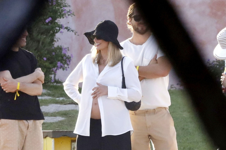 *PREMIUM-EXCLUSIVE* MUST CALL FOR PRICING BEFORE USAGE  - Heavily pregnant Australian actress Margot Robbie looks radiant as she shows off her growing baby bump while pictured with her husband Tom Ackerley and friends enjoying summer vacation in Sardinia.