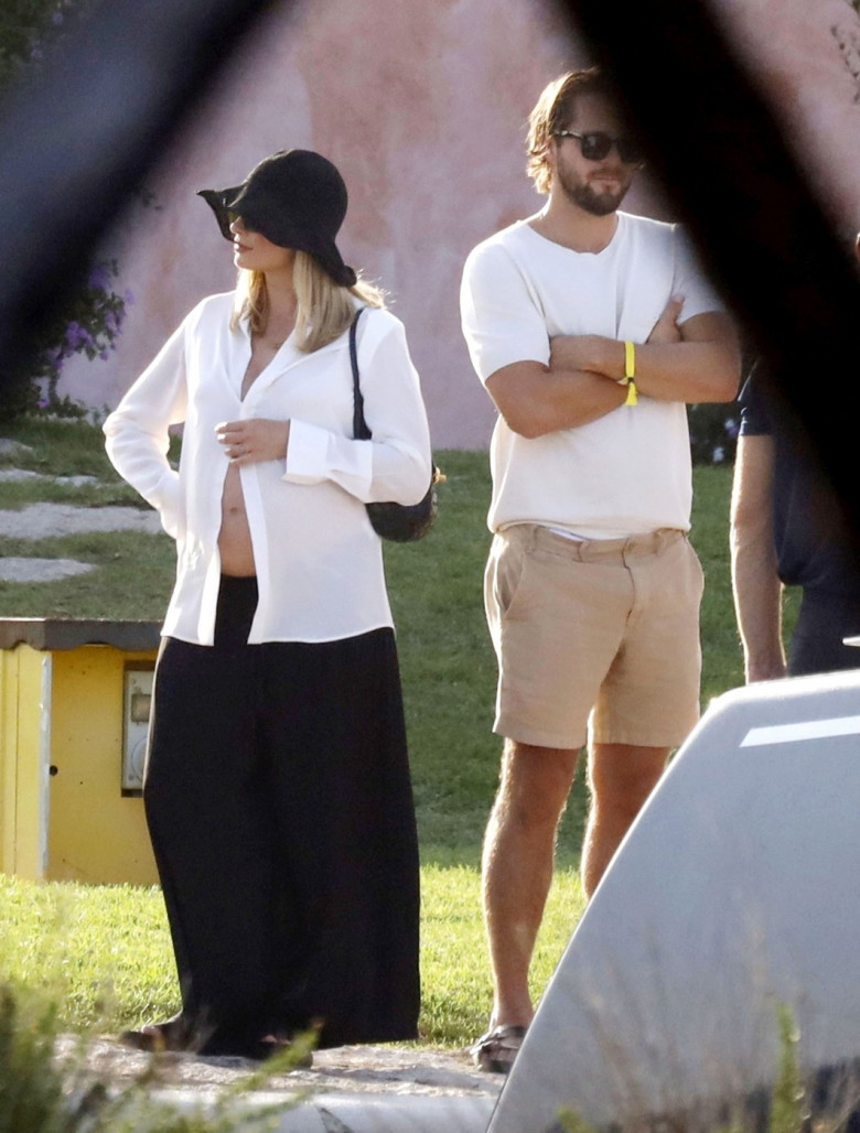 *PREMIUM-EXCLUSIVE* MUST CALL FOR PRICING BEFORE USAGE  - Heavily pregnant Australian actress Margot Robbie looks radiant as she shows off her growing baby bump while pictured with her husband Tom Ackerley and friends enjoying summer vacation in Sardinia.