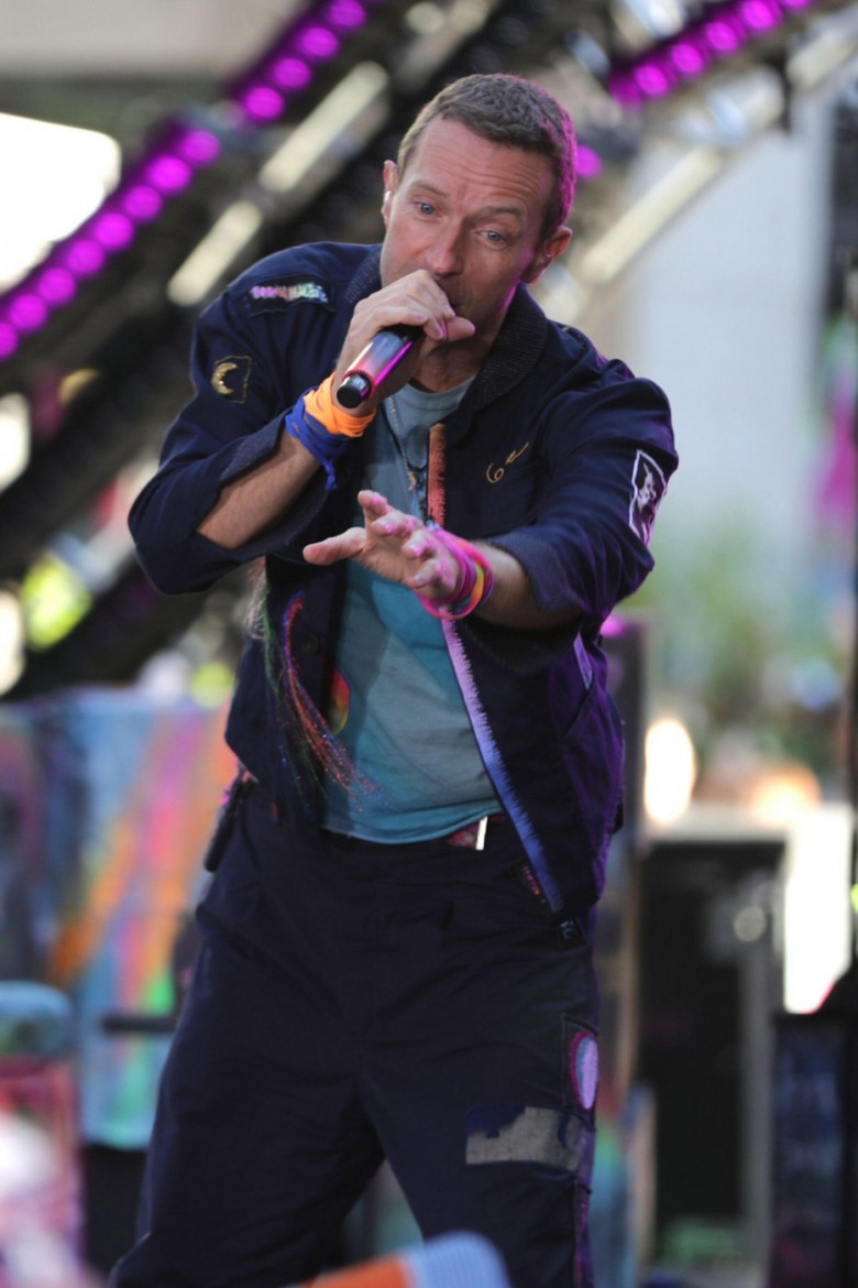 NEW YORK, NEW YORK - OCTOBER 08: Chris Martin of Coldplay performs live on NBC's "Today" show at Rockefeller Plaza on October 08, 2024, in New York City. The British rock band delivered an energetic performance, captivating the audience with their hit son