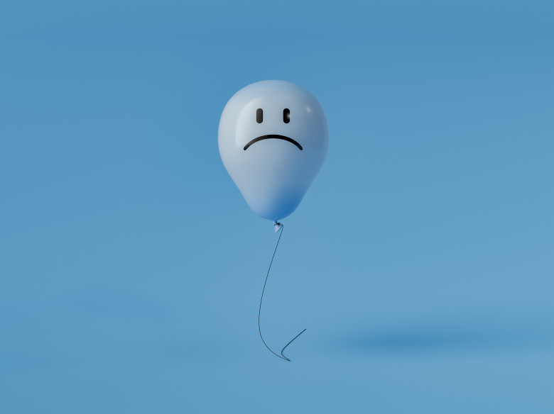 Blue monday concept with sad face balloon floating on blue background