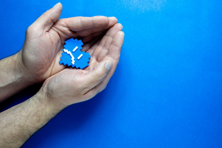 Blue Monday Concept. Hands of a man holding a blue heart.