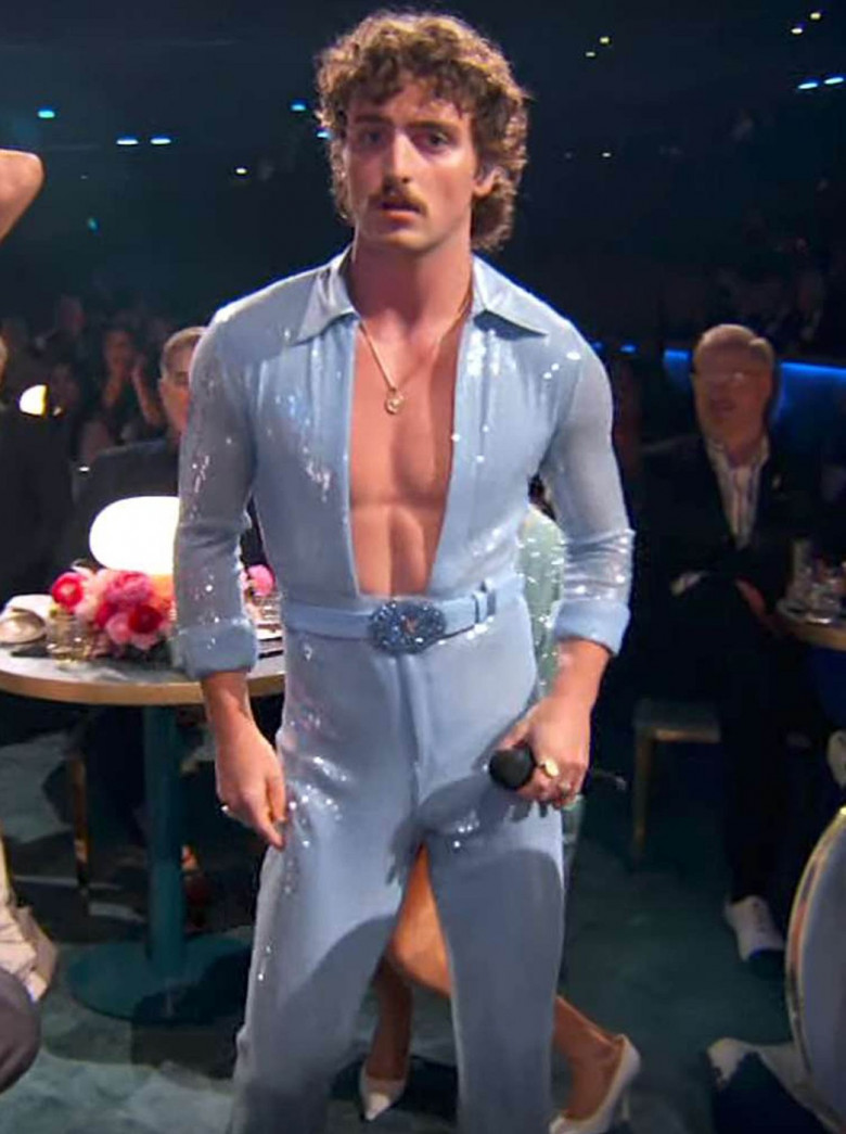 Benson Boone stripped from a suit into a sheer jumpsuit at the 2025 Grammys with help from Heidi Klum and Nikki Glaser.