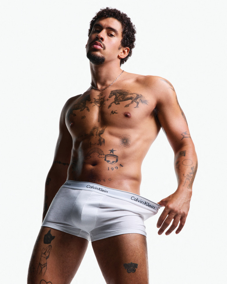 Bad Bunny shows off his ripped torso as he strips down for Calvin Klein's racy new underwear campaign.