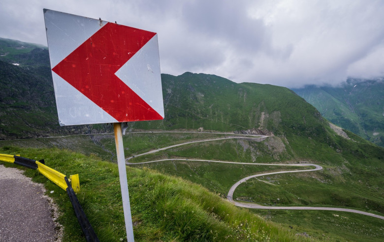 Sharp bend chevron sign on Transfagarasan Road (DN7C also known as Ceaușescu's Folly) crossing the southern Carpathian Mountains in Romania