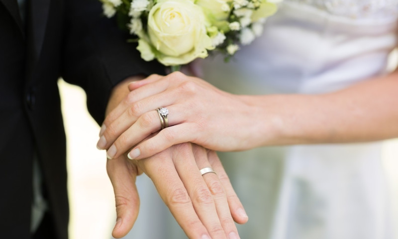 Bride and groom showing wedding rings