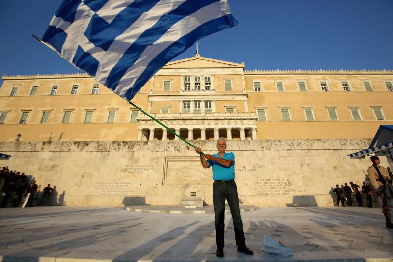 grecia om cu steag in fata parlamentului 1007GettyImages-480064338