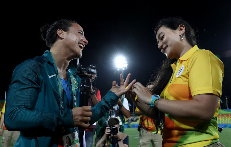 RIO DE JANEIRO, BRAZIL - AUGUST 08: Volunteer Marjorie Enya (R) proposes marriage to rugby player Isadora Cerullo of Brazil after the Women's Gold Medal Rugby Sevens match between Australia and New Zealand on Day 3 of the Rio 2016 Olympic Games at the Deodoro Stadium on August 8, 2016 in Rio de Janeiro, Brazil. (Photo by David Rogers/Getty Images)
