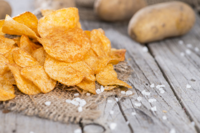 Heap,Of,Paprika,Potato,Chips,On,Rustic,Background