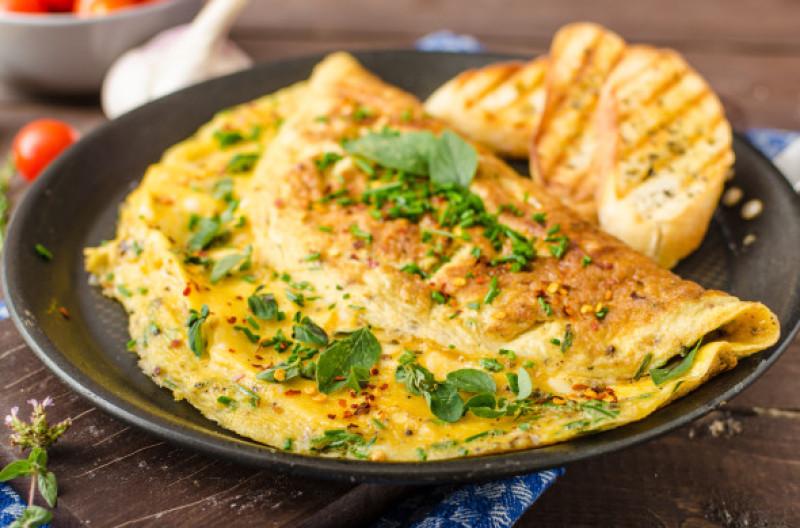 Herb,Omelette,With,Chives,And,Oregano,Sprinkled,With,Chili,Flakes,