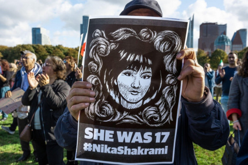 A protester holds a portrait of a 17-year-old Nika Shakarami during the demonstration on the Malieveld, The Hague. Iranians and their supporters gathered hundreds strong in The Hague, in support of Iranians protesting on the streets of Iran. Security forc