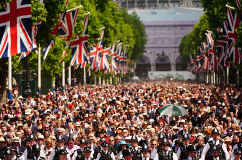 People walk down the Mall after Trooping the Colour ceremony in central London as King Charles III celebrates his official birthday. Picture date: Saturday June 14, 2025.
