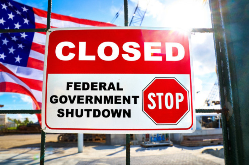 Germany - October 2, 2025: PHOTOMONTAGE, Closed sign on a fence with USA flag and the words: Stop, Federal Government Sh