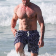 *PREMIUM-EXCLUSIVE* 'Wolverine' star Hugh Jackman shows off his muscular physique as he hits the beach for an early morning swim in Bondi