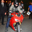 Tom Cruise rides out of a party at Sunset on a red Ducati