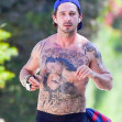 EXCLUSIVE: Shia LaBeouf still has an injured right hand as he takes a shirtless walk around his neighborhood