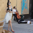 Famke Janssen takes pictures of art on boarded stores windows in Soho, NYC