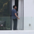 Ben Affleck takes a smoke break on his hotel balcony while out staying in Miami
