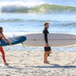 EXCLUSIVE: *NO DAILYMAIL ONLINE* Simon Baker Suffers A Cheeky Wetsuit Wardrobe-Malfunction During A Surf Session With Girlfriend Laura May Gibbs In Byron Bay