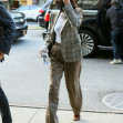 Dakota Johnson wears a plaid blazer as she returns to The Bowery Hotel