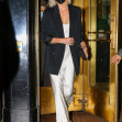Charlize Theron wears a white satin dress with a black jacket as heading out for a meetings in New York City