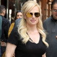 EXCLUSIVE: Rebel Wilson Heads To The Airport In A Casual Black Top, Pants And Flats - Carrying A Small Leather Tote, In New York City