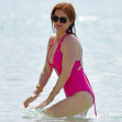 *EXCLUSIVE* WEB MUST CALL FOR PRICING  - Borat star Sacha Baron Cohen shows off his toned torso as he joins chic wife Isla Fisher in pink swimsuit on the beach while holidaying in Barbados.