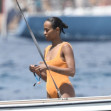 *EXCLUSIVE* Showing off her sexy little figure wearing her striking orange swimsuit, Zoe Saldana and husband Marco Perego enjoy a swim at Pevero beach during their family holiday in Sardinia.