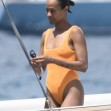 *EXCLUSIVE* Showing off her sexy little figure wearing her striking orange swimsuit, Zoe Saldana and husband Marco Perego enjoy a swim at Pevero beach during their family holiday in Sardinia.