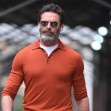 Hugh Jackman wears an orange pullover shirt and brown suede shoes in New York City