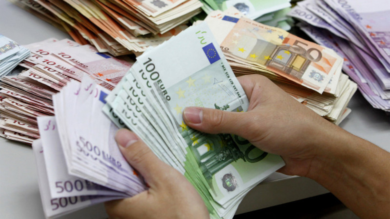 A bank employee counts Euro notes at Kasikornbank in Bangkok