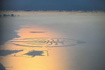 Dubai, United Arab Emirates. 01st Dec, 2023. View of the artificial archipelago of The Palm Jumeirah in the Persian Gulf from a height of around 2000 meters. The backlight of the low evening sun colors the water reddish to orange. Credit: Soeren Stache/dp