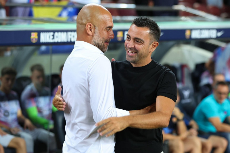 Barcelona, Spain. 24th Aug, 2022. Pep Guardiola of Manchester City with Xavi Hernandez of FC Barcelona during the benefic friendly match to raise funds for ELA between FC Barcelona and Manchester City at Spotify Camp Nou in Barcelona, Spain. Credit: DAX I