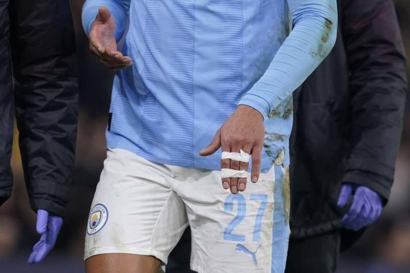 MANCHESTER, ENGLAND, 6th March 2024. Matheus Nunes of Manchester City leaves the pitch after he suffers a dislocated fin