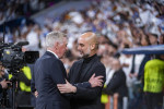 Carlo Ancelotti (L), coach of Real Madrid, hugs Josep Pep Guardiola (R), head coach of Manchester City, before the UEFA