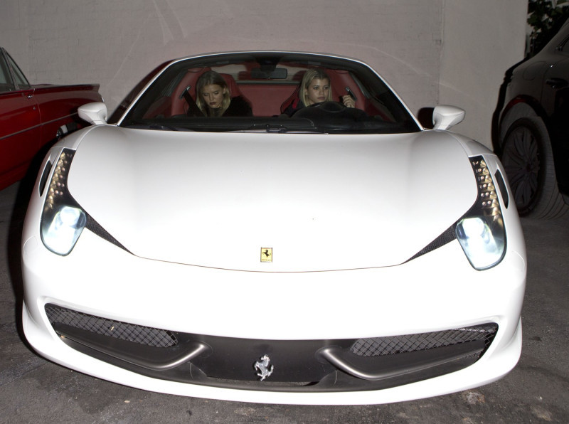 Sofia Richie seen in her Brand News $350,000 White Ferrari 488 GTB and has a slight 'Wardrobe malfunction' getting into the sports car while leaving 'Delilah' Bar in West hollywood, CA