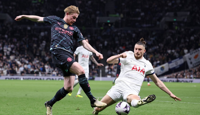 London, England, 14th May 2024. Kevin De Bruyne of Manchester City shot blocked by Radu Dragusin of Tottenham during the