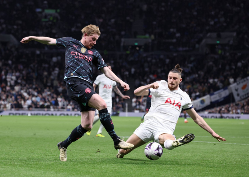 London, England, 14th May 2024. Kevin De Bruyne of Manchester City shot blocked by Radu Dragusin of Tottenham during the