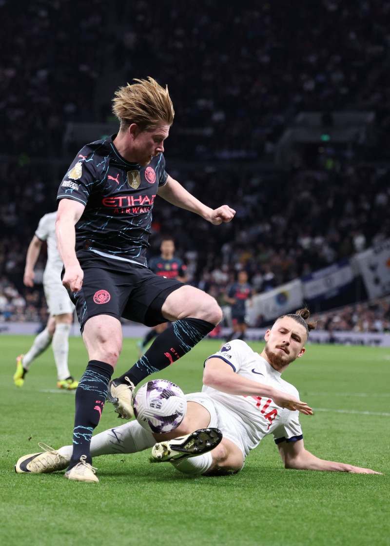 London, England, 14th May 2024. Kevin De Bruyne of Manchester City shot blocked by Radu Dragusin of Tottenham during the