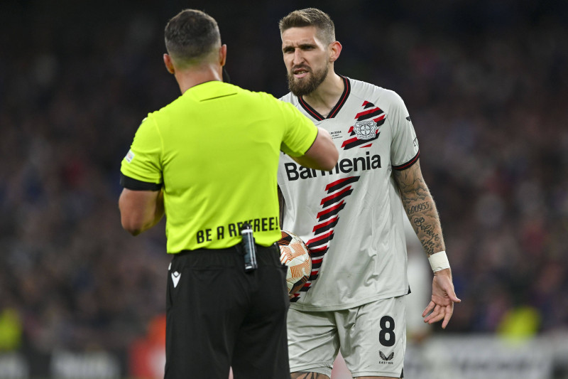 DUBLIN, IRELAND - MAY 22: referee Istvan Kovacs gives Robert Andrich of Leverkusen a yellow card during the UEFA Europa