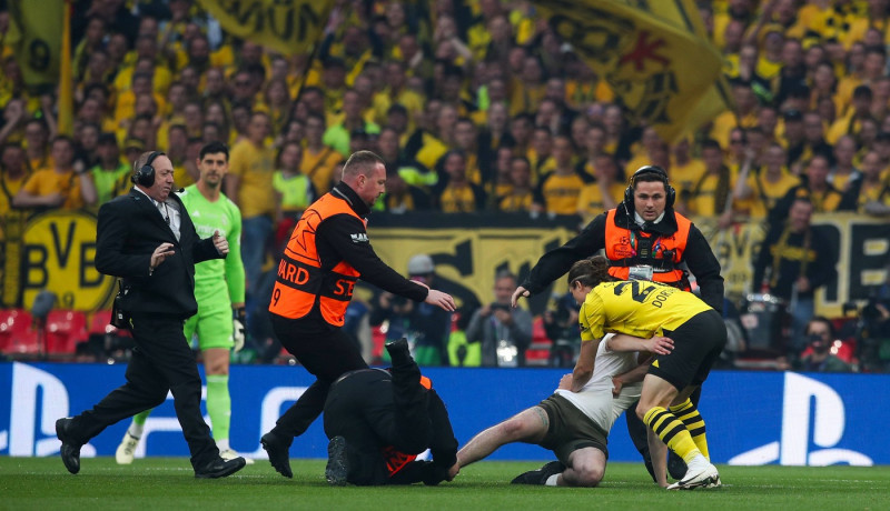 Borussia Dortmund v Real Madrid, London, UK - 1 Jun 2024 A pitch invader is tackled by stewards and Marcel Sabitzer of B