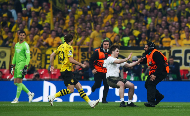 Borussia Dortmund v Real Madrid, London, UK - 1 Jun 2024 A pitch invader is tackled by stewards and Marcel Sabitzer of B